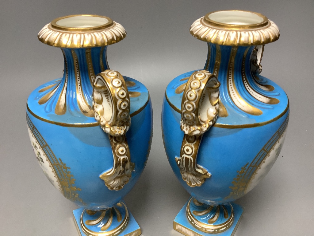 A pair of mid 19th century Coalport turquoise ground two handled vases, painted in Sévres style with birds in gilt panels 20.5cm